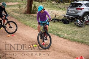 woman mountain biker practicing track standing