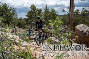 woman mountain biker negotiating technical uphill climb