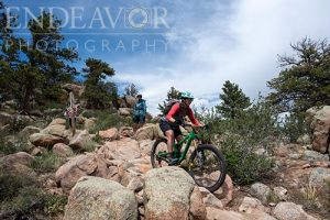 mountain biker descending rocky trail